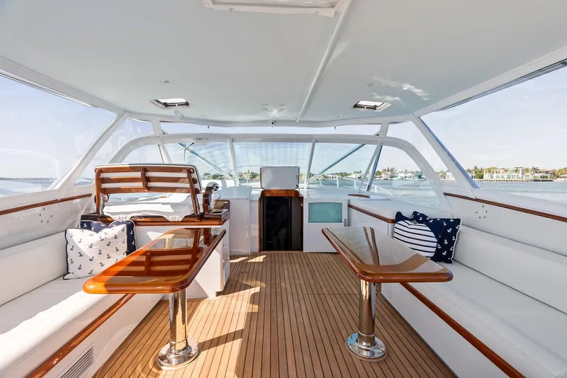 Slide: The Image of Luxurious 2000 Rybovich Sportfish yacht interior with wooden accents and plush seating. - 24