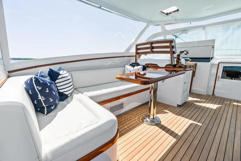 Slide: The Image of Luxurious 2000 Rybovich Sportfish yacht interior with wooden deck and cushioned seating. - 25