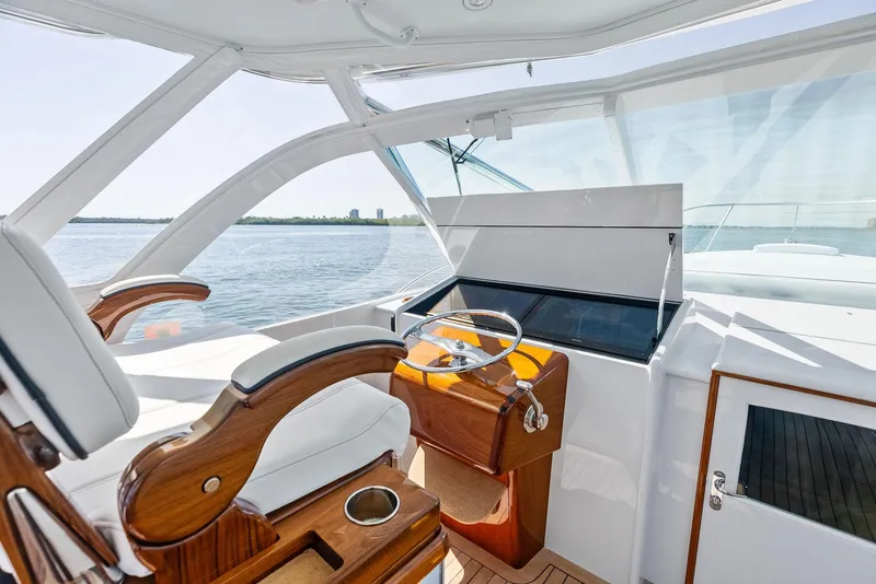 Slide: The Image of 2000 Rybovich Sportfish yacht helm with wooden accents and ocean view. - 28