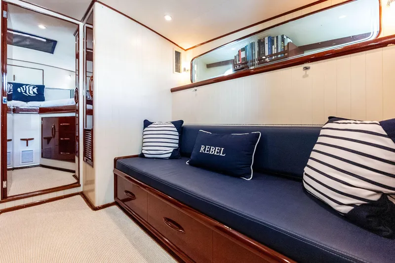 Slide: The Image of Luxurious 2000 Rybovich Sportfish interior with navy seating and striped pillows. - 33