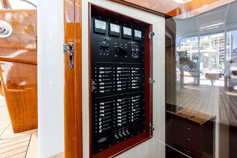 Slide: The Image of Electrical panel on a 2000 Rybovich Sportfish boat, featuring gauges and switches. - 35