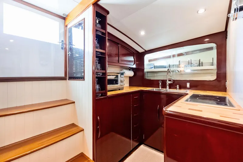 Slide: The Image of Luxurious 2000 Rybovich Sportfish yacht interior with modern kitchen and wooden cabinetry. - 36