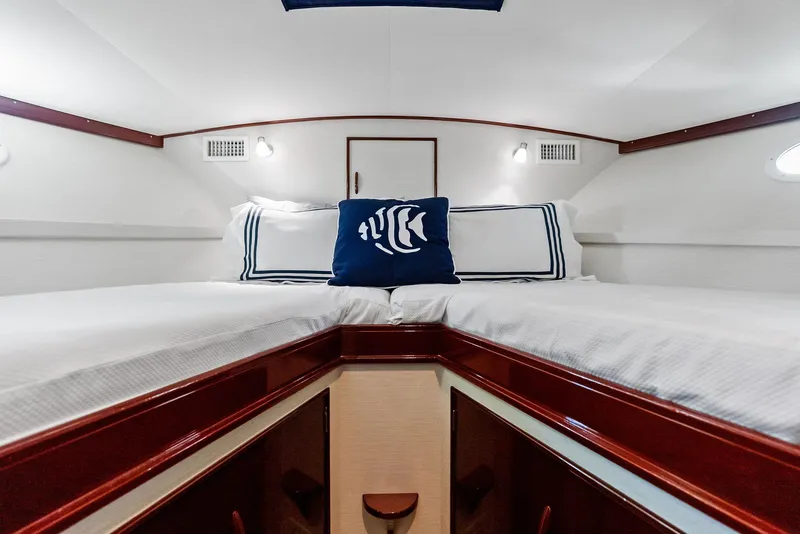 Slide: The Image of Interior cabin of 2000 Rybovich Sportfish boat with twin beds and nautical decor. - 38