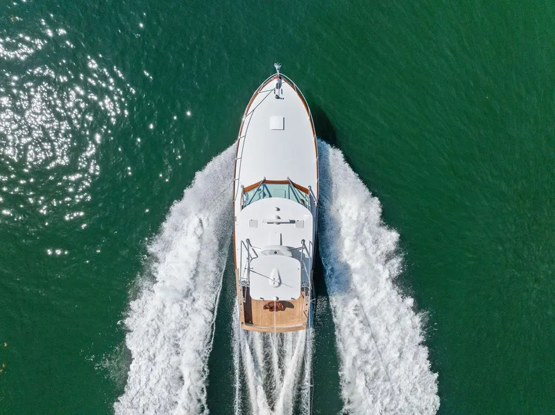 Slide: The Image of Aerial view of 2000 Rybovich Sportfish yacht cruising on green water. - 4