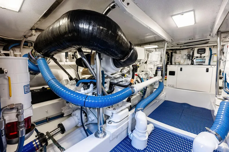 Slide: The Image of Engine room of a 2000 Rybovich Express with blue hoses. - 42