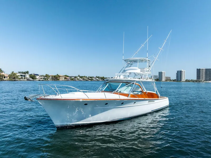 Slide: The Image of Rybovich Sportfish 2000 yacht on calm water with clear blue sky background. - 8