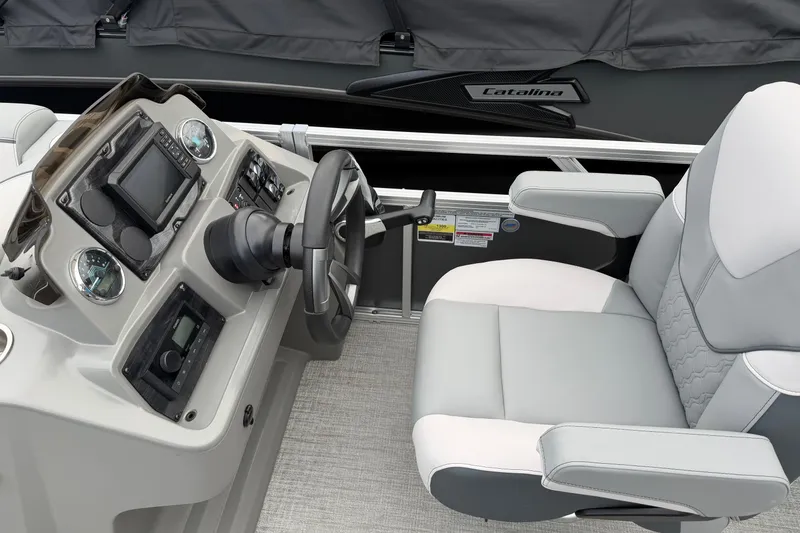 Slide: The Image of 2026 Avalon VENTURE QUAD LOUNGER boat interior with steering console and captain's chair. - 4