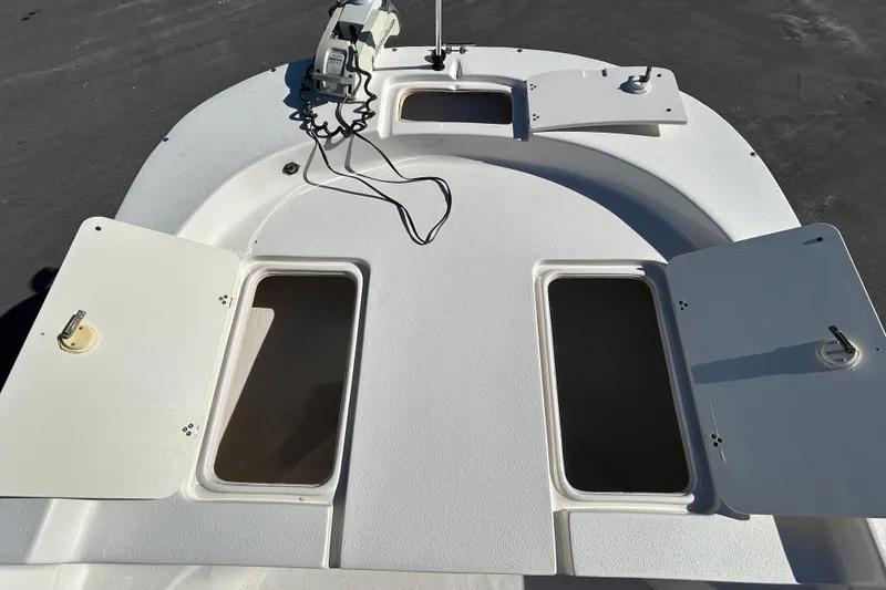 Slide: The Image of 2017 Carolina Skiff 258 DLV boat deck with open storage compartments. - 13
