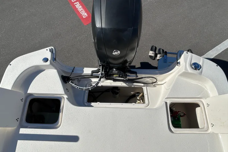 Slide: The Image of 2017 Carolina Skiff 258 DLV boat engine and storage compartments. - 16