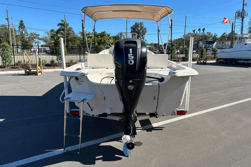 Slide: The Image of 2017 Carolina Skiff 258 DLV boat with 150 HP outboard motor, parked outdoors. - 3