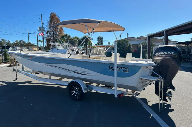 Slide: The Image of 2017 Carolina Skiff 258 DLV boat with Mercury outboard motor on trailer. - 4