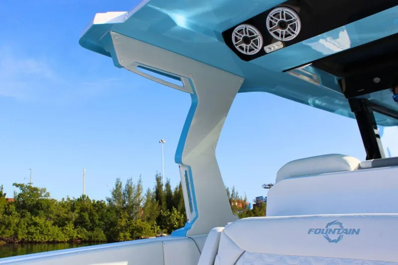 Slide: The Image of 2025 Fountain 38 SCX boat interior with speakers, blue sky, and lush greenery. - 11