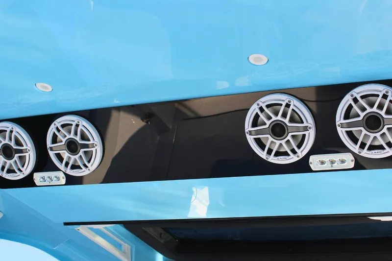 Slide: The Image of 2025 Fountain 38 SCX boat speakers and lights on a sleek blue panel. - 12