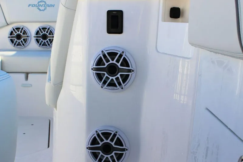 Slide: The Image of 2025 Fountain 38 SCX boat interior with JL Audio speakers and sleek white design. - 21