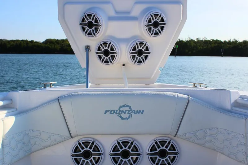 Slide: The Image of 2025 Fountain 38 SCX boat speakers and seating, on a serene water backdrop. - 24