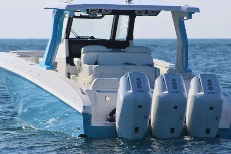 Slide: The Image of 2025 Fountain 38 SCX boat with triple 400 V10 engines on open water. - 3