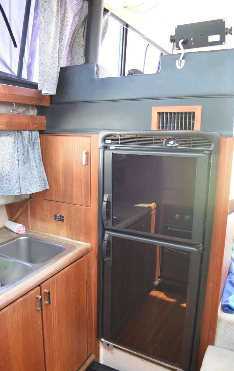 Slide: The Image of 1990 Bayliner 3888 Motoryacht interior with kitchen and refrigerator. - 17