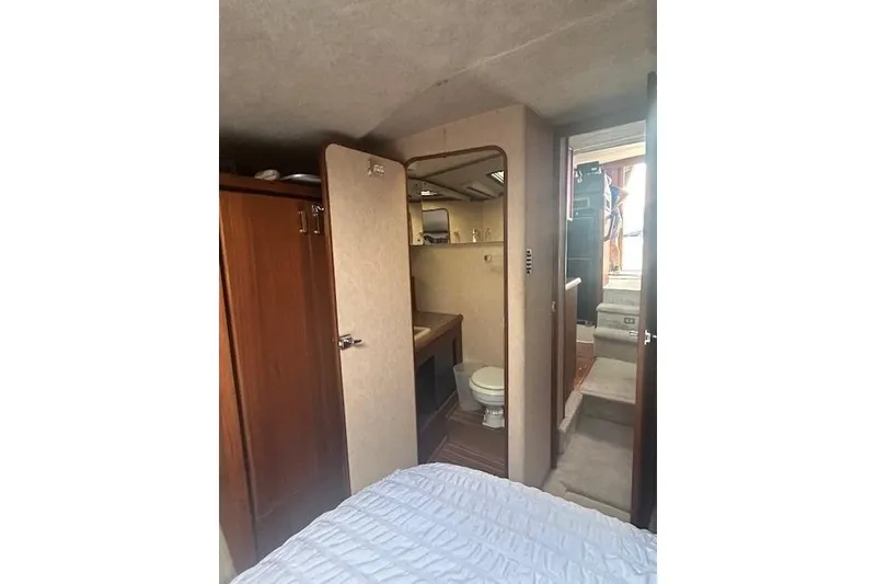 Slide: The Image of Interior of 1990 Bayliner 3888 Motoryacht showing bathroom and cabin area. - 27