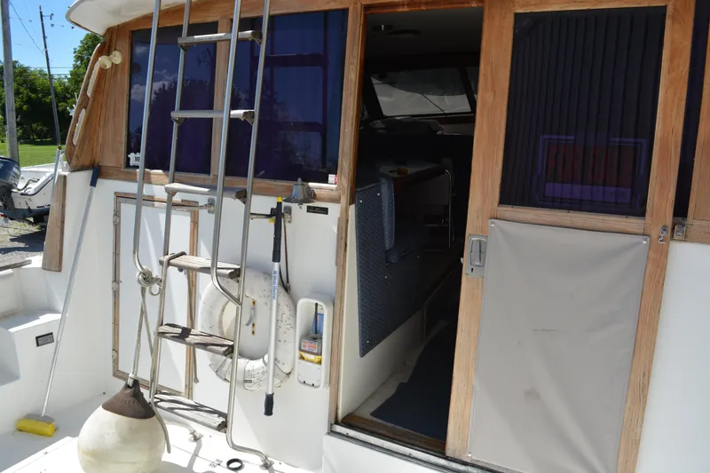 Slide: The Image of 1990 Bayliner 3888 Motoryacht with open door and ladder. - 3