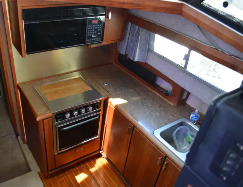 Slide: The Image of 1990 Bayliner 3888 Motoryacht kitchen with stove and sink. - 6