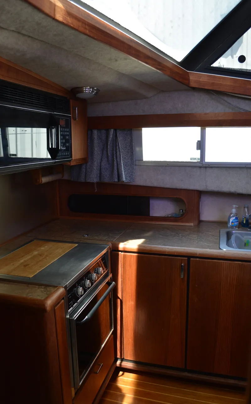 Slide: The Image of Interior of 1990 Bayliner 3888 Motoryacht with kitchen area. - 8