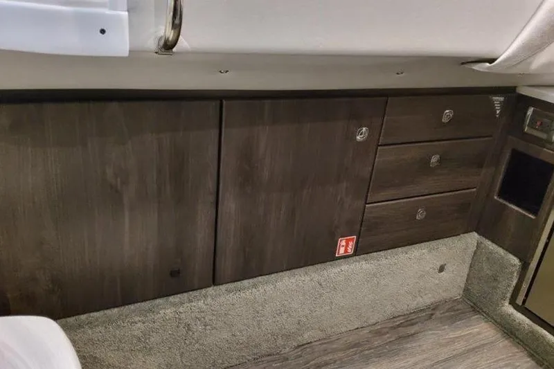 Slide: The Image of Interior of 2025 Formula 350 Crossover Bowrider I/O with wood cabinetry and carpeted flooring. - 12