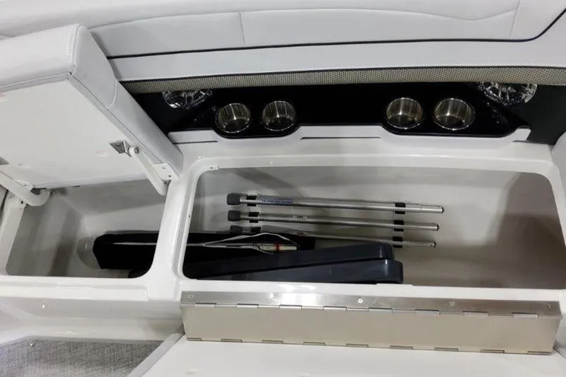 Slide: The Image of 2025 Formula 350 Crossover Bowrider I/O storage compartment with cup holders and equipment. - 18