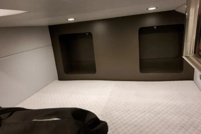 Slide: The Image of 2025 Formula 350 Crossover Bowrider I/O cabin interior with quilted bedding and recessed lighting. - 8