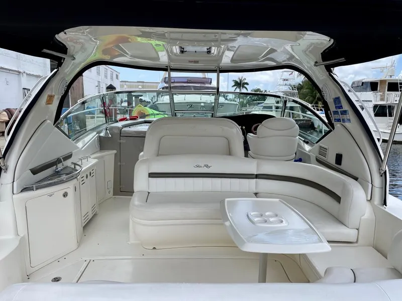 Slide: The Image of 2007 Sea Ray 44 Sundancer yacht interior with white seating and table. - 10