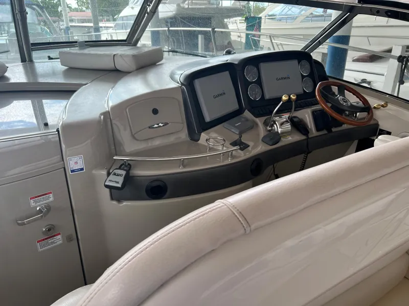 Slide: The Image of 2007 Sea Ray 44 Sundancer helm with dual Garmin displays and leather seating. - 23