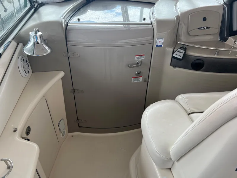 Slide: The Image of Interior of 2007 Sea Ray 44 Sundancer yacht, featuring helm seating and cabin door. - 24