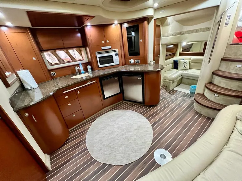 Slide: The Image of Luxurious interior of 2007 Sea Ray 44 Sundancer yacht with modern kitchen and seating area. - 25