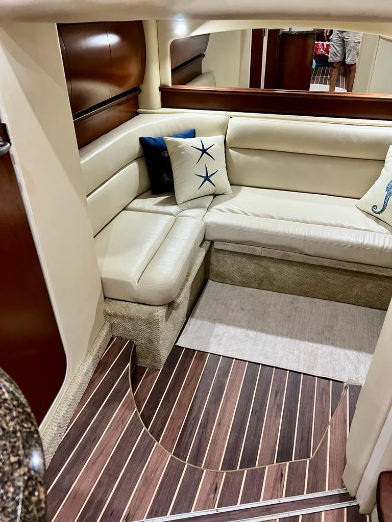 Slide: The Image of 2007 Sea Ray 44 Sundancer interior with beige leather seating and nautical-themed pillows. - 26