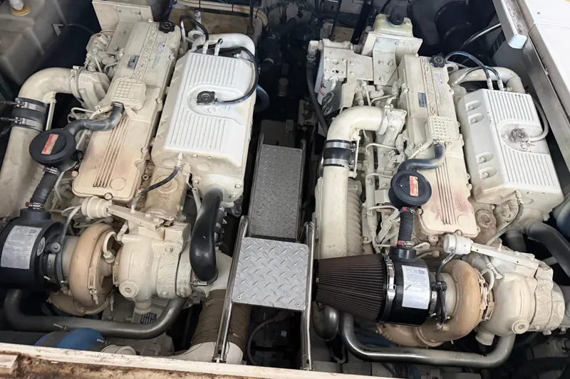 Slide: The Image of Twin engines of a 2007 Sea Ray 44 Sundancer yacht, showcasing detailed machinery. - 42