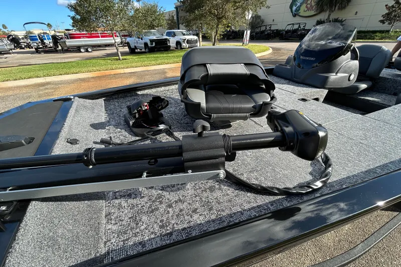 Slide: The Image of 2026 Tracker Pro 170 boat deck with seating and trolling motor, parked outdoors. - 10