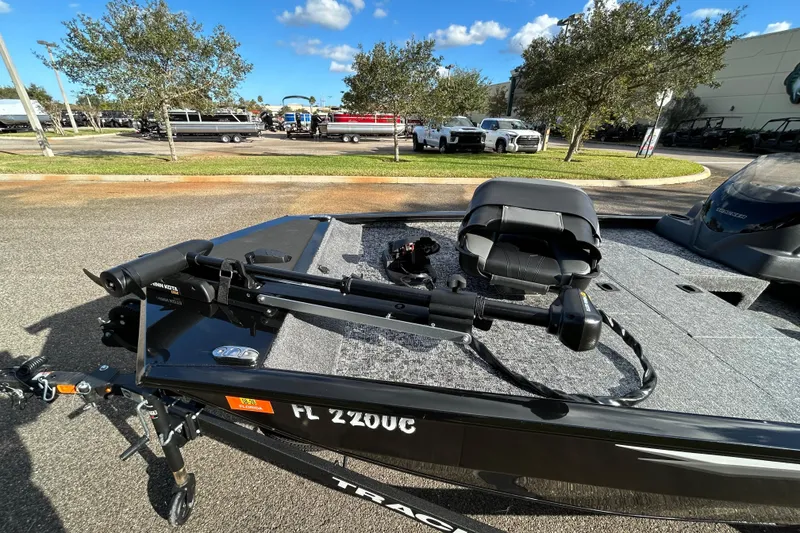 Slide: The Image of 2026 Tracker Pro 170 boat with trolling motor and seat, parked outdoors. - 11