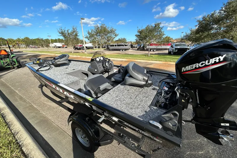 Slide: The Image of 2026 Tracker Pro 170 boat with Mercury engine on a trailer, parked outdoors. - 4