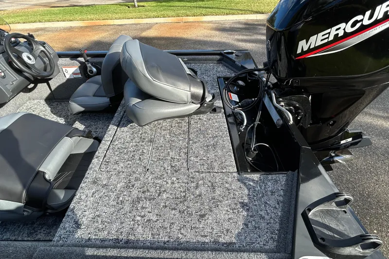 Slide: The Image of 2026 Tracker Pro 170 boat interior with Mercury engine, featuring gray seating and carpeted deck. - 6