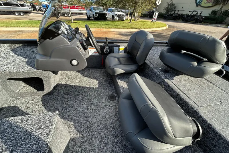 Slide: The Image of 2026 Tracker Pro 170 boat interior with gray seating and steering console. - 8