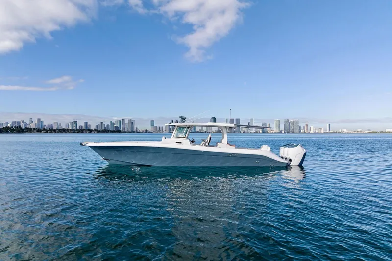 The Image of 2023 HCB 42 Lujo boat on calm water with city skyline in background. - 0