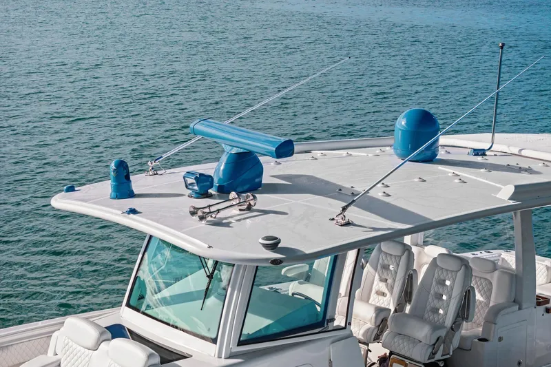 Slide: The Image of 2023 HCB 42 Lujo boat with advanced radar equipment on calm water. - 11