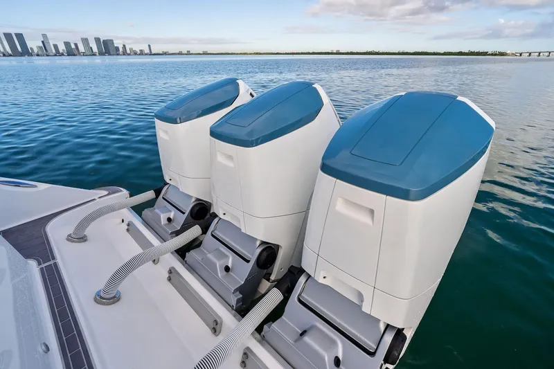 Slide: The Image of 2023 HCB 42 Lujo boat with triple outboard engines on calm water. - 12