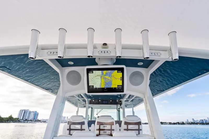 Slide: The Image of 2023 HCB 42 Lujo boat helm with navigation screen and rod holders. - 17
