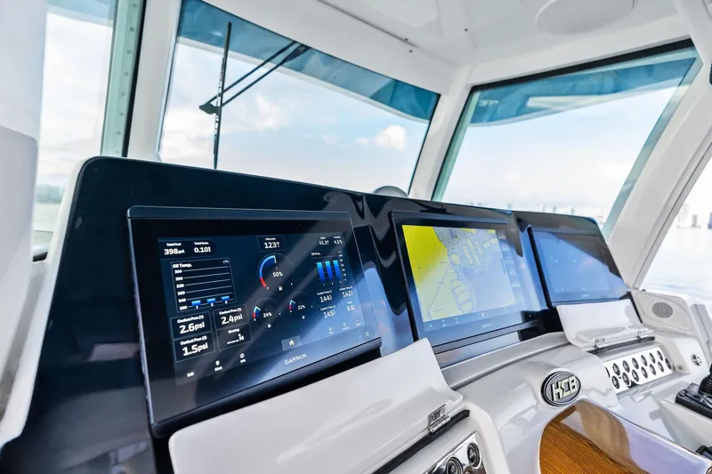 Slide: The Image of Helm of 2023 HCB 42 Lujo with advanced navigation displays and controls. - 27