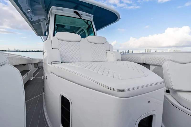 Slide: The Image of 2023 HCB 42 Lujo luxury boat with white cushioned seating and sleek design. - 32