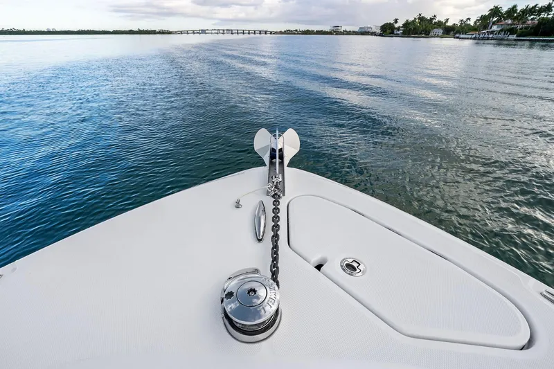 Slide: The Image of Bow of 2023 HCB 42 Lujo boat on calm water, showcasing anchor and deck. - 35