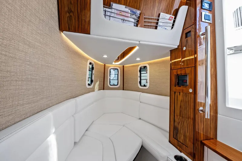 Slide: The Image of Luxurious interior of 2023 HCB 42 Lujo boat with white seating and wood accents. - 36