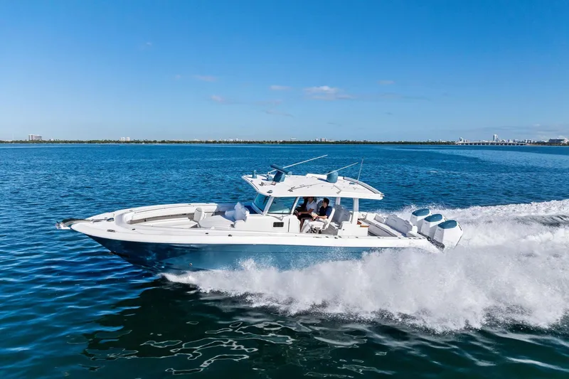 Slide: The Image of 2023 HCB 42 Lujo boat cruising on open water under clear blue skies. - 7
