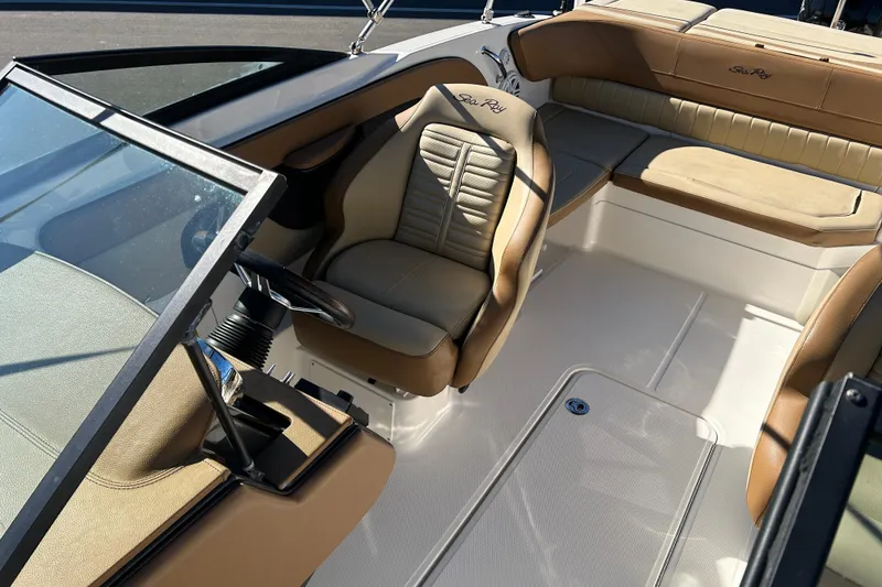 Slide: The Image of 2018 Sea Ray SPX 210 Outboard interior with tan seating and steering wheel. - 10