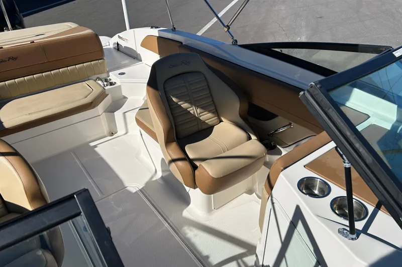 Slide: The Image of 2018 Sea Ray SPX 210 Outboard boat interior with tan seating and cup holders. - 11